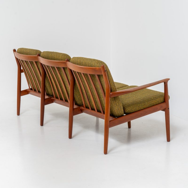 Impressive 3-seater sofa by Grete Jalk for Glostrup (Denmark, 1960s). What an eye catcher.. it features a solid teak frame which is beautifully sculpted and the original cushions! The green/yellow wool fabric is original aswell and remains in amazing condition. Obviously an example of true Scandinavian craftsmanship. It is a pleasure for the eyes and a pleasure to sit in! Marked by maker.