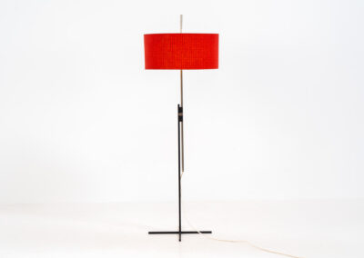 Rare minimalist floor lamp by Kaiser Leuchten (Germany, 1960s).It contains a minimalistic black base, a chrome arm and the original large fabric shade with a red & black check pattern.It is adjustable in height with a clamping mechanism. The light comes out primarily directed downwards and upwards.The lamp has a pull cord as a switch. It has 3 switching modes. The 2 burning points can be turned on and off individually, so that only one bulb burns when needed.In very good and original condition with a few sings of age and use.Labeled by maker.
