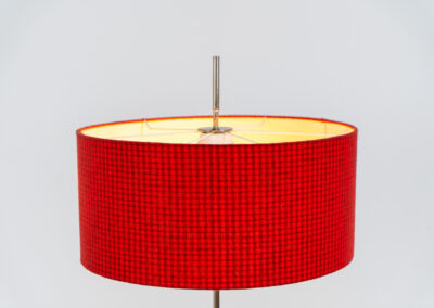 Rare minimalist floor lamp by Kaiser Leuchten (Germany, 1960s).It contains a minimalistic black base, a chrome arm and the original large fabric shade with a red & black check pattern.It is adjustable in height with a clamping mechanism. The light comes out primarily directed downwards and upwards.The lamp has a pull cord as a switch. It has 3 switching modes. The 2 burning points can be turned on and off individually, so that only one bulb burns when needed.In very good and original condition with a few sings of age and use.Labeled by maker.