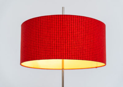 Rare minimalist floor lamp by Kaiser Leuchten (Germany, 1960s).It contains a minimalistic black base, a chrome arm and the original large fabric shade with a red & black check pattern.It is adjustable in height with a clamping mechanism. The light comes out primarily directed downwards and upwards.The lamp has a pull cord as a switch. It has 3 switching modes. The 2 burning points can be turned on and off individually, so that only one bulb burns when needed.In very good and original condition with a few sings of age and use.Labeled by maker.