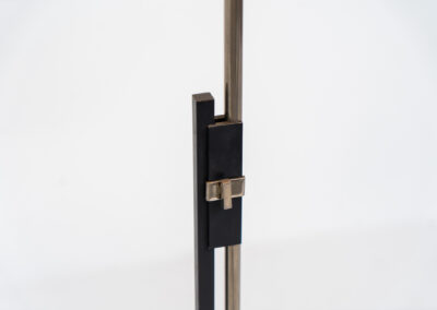 Rare minimalist floor lamp by Kaiser Leuchten (Germany, 1960s).It contains a minimalistic black base, a chrome arm and the original large fabric shade with a red & black check pattern.It is adjustable in height with a clamping mechanism. The light comes out primarily directed downwards and upwards.The lamp has a pull cord as a switch. It has 3 switching modes. The 2 burning points can be turned on and off individually, so that only one bulb burns when needed.In very good and original condition with a few sings of age and use.Labeled by maker.