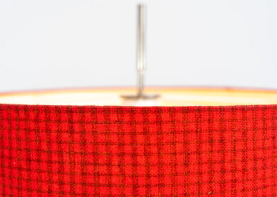 Rare minimalist floor lamp by Kaiser Leuchten (Germany, 1960s).It contains a minimalistic black base, a chrome arm and the original large fabric shade with a red & black check pattern.It is adjustable in height with a clamping mechanism. The light comes out primarily directed downwards and upwards.The lamp has a pull cord as a switch. It has 3 switching modes. The 2 burning points can be turned on and off individually, so that only one bulb burns when needed.In very good and original condition with a few sings of age and use.Labeled by maker.