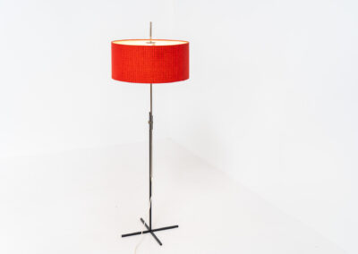 Rare minimalist floor lamp by Kaiser Leuchten (Germany, 1960s).It contains a minimalistic black base, a chrome arm and the original large fabric shade with a red & black check pattern.It is adjustable in height with a clamping mechanism. The light comes out primarily directed downwards and upwards.The lamp has a pull cord as a switch. It has 3 switching modes. The 2 burning points can be turned on and off individually, so that only one bulb burns when needed.In very good and original condition with a few sings of age and use.Labeled by maker.