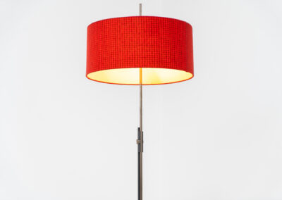 Rare minimalist floor lamp by Kaiser Leuchten (Germany, 1960s).It contains a minimalistic black base, a chrome arm and the original large fabric shade with a red & black check pattern.It is adjustable in height with a clamping mechanism. The light comes out primarily directed downwards and upwards.The lamp has a pull cord as a switch. It has 3 switching modes. The 2 burning points can be turned on and off individually, so that only one bulb burns when needed.In very good and original condition with a few sings of age and use.Labeled by maker.
