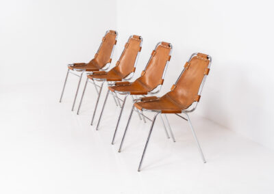 Stunning set of 4 ‘Les Arcs’ chairs selected by Charlotte Perriand for Les Arcs and produced by Cassina (Italy, 1960s). Charlotte Perriand collaborated with Jean Prouvé and Pierre Jeanneret for this iconic design. They are made out of a chrome tubular frame and a cow leather cognac upholstery. Characterized by their sleek metal frames and ergonomic design, they reflect Perriand’s commitment to both form and function, embodying the modernist aesthetic of the time. The Les Arcs chairs remain iconic pieces of furniture and highly collectible. In very good condition with a beautiful patina on the leather!