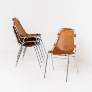 Stunning set of 4 ‘Les Arcs’ chairs selected by Charlotte Perriand for Les Arcs and produced by Cassina (Italy, 1960s). Charlotte Perriand collaborated with Jean Prouvé and Pierre Jeanneret for this iconic design. They are made out of a chrome tubular frame and a cow leather cognac upholstery. Characterized by their sleek metal frames and ergonomic design, they reflect Perriand’s commitment to both form and function, embodying the modernist aesthetic of the time. The Les Arcs chairs remain iconic pieces of furniture and highly collectible. In very good condition with a beautiful patina on the leather!