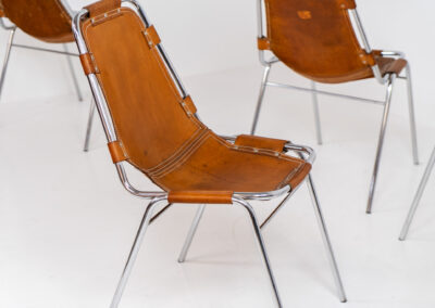 Stunning set of 4 ‘Les Arcs’ chairs selected by Charlotte Perriand for Les Arcs and produced by Cassina (Italy, 1960s). Charlotte Perriand collaborated with Jean Prouvé and Pierre Jeanneret for this iconic design. They are made out of a chrome tubular frame and a cow leather cognac upholstery. Characterized by their sleek metal frames and ergonomic design, they reflect Perriand’s commitment to both form and function, embodying the modernist aesthetic of the time. The Les Arcs chairs remain iconic pieces of furniture and highly collectible. In very good condition with a beautiful patina on the leather!