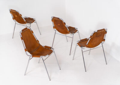 Stunning set of 4 ‘Les Arcs’ chairs selected by Charlotte Perriand for Les Arcs and produced by Cassina (Italy, 1960s). Charlotte Perriand collaborated with Jean Prouvé and Pierre Jeanneret for this iconic design. They are made out of a chrome tubular frame and a cow leather cognac upholstery. Characterized by their sleek metal frames and ergonomic design, they reflect Perriand’s commitment to both form and function, embodying the modernist aesthetic of the time. The Les Arcs chairs remain iconic pieces of furniture and highly collectible. In very good condition with a beautiful patina on the leather!