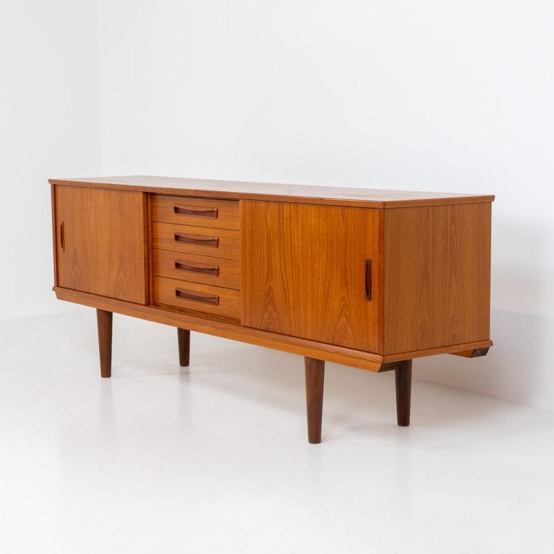 Beautiful Danish sideboard in teak, 1960s. The designer is unknown for now, but it is clearly a well-built and very aesthetic piece! It contains two sliding doors with shelves on the inside and four drawers with stunning organic inset handles on them. Another feature on this one is that it has a veneered backside, so it can be placed in the center of a room, as a room devider for example. The sideboard is in very good condition!