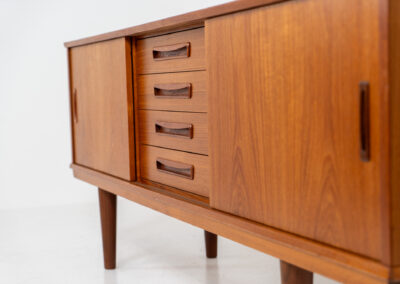 Beautiful Danish sideboard in teak, 1960s. The designer is unknown for now, but it is clearly a well-built and very aesthetic piece! It contains two sliding doors with shelves on the inside and four drawers with stunning organic inset handles on them. Another feature on this one is that it has a veneered backside, so it can be placed in the center of a room, as a room devider for example. The sideboard is in very good condition!
