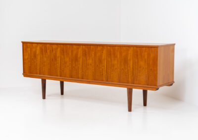 Beautiful Danish sideboard in teak, 1960s. The designer is unknown for now, but it is clearly a well-built and very aesthetic piece! It contains two sliding doors with shelves on the inside and four drawers with stunning organic inset handles on them. Another feature on this one is that it has a veneered backside, so it can be placed in the center of a room, as a room devider for example. The sideboard is in very good condition!
