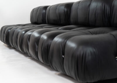 “Camaleonda” sofa by Mario Bellini for C&B Italia, 1970s This particular Camaleonda sofa represents a first edition crafted by C&B Italia, the predecessor of B&B Italia. Upholstered in its original black leather fabric, it comprises four modular sections totaling ten pieces. Originating from the 1970s, it has signs of use expected with its age, yet remains free from tears or significant scratches. The leather retains a remarkable vintage condition, adorned with a beautiful patina.