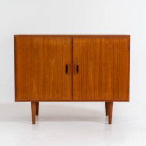 Midcentury cabinet by Børge Mogensen for Søborg Møbelfabrik (Denmark, 1960s). A simple and well-built piece by one of Denmark’s most influential designers, Børge Mogensen. It contains two doors with stunningly sculpted handles. Except for a small restoration mark on the back corner this piece is in wonderful condition. Labeled by maker and original key included.