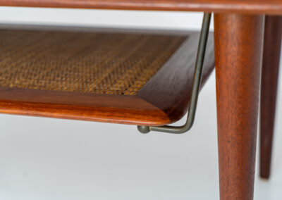 Highly collectible FD-516 coffee table by Peter Hvidt & Orla Mølgaard for France & Søn (Denmark, 1960s). This rare and important FD-516 model features a solid teak table top and solid legs. It has an additional magazine area made of rattan mesh, which is worn by brass fittings. An example of a highly detailed and high quality Scandinavian design classic in very good condition. Marked by maker.