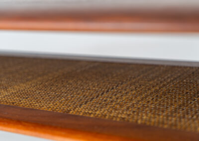 Highly collectible FD-516 coffee table by Peter Hvidt & Orla Mølgaard for France & Søn (Denmark, 1960s). This rare and important FD-516 model features a solid teak table top and solid legs. It has an additional magazine area made of rattan mesh, which is worn by brass fittings. An example of a highly detailed and high quality Scandinavian design classic in very good condition. Marked by maker.