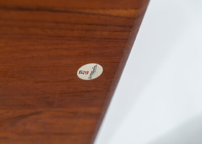 Highly collectible FD-516 coffee table by Peter Hvidt & Orla Mølgaard for France & Søn (Denmark, 1960s). This rare and important FD-516 model features a solid teak table top and solid legs. It has an additional magazine area made of rattan mesh, which is worn by brass fittings. An example of a highly detailed and high quality Scandinavian design classic in very good condition. Marked by maker.