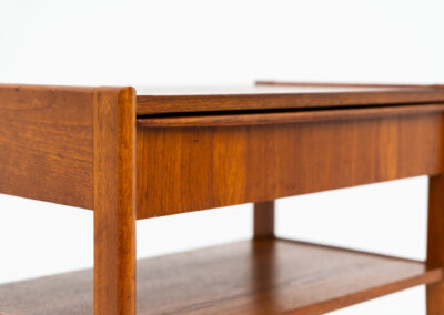 Danish trolley / sidetable in teak, 1960s A simple rolling sidetable with one drawer featuring a nicely sculpted handle, a warm woodgrain and some brass details on the wheels. In good condition with normal using traces.
