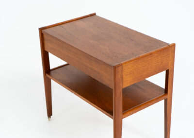 Danish trolley / sidetable in teak, 1960s A simple rolling sidetable with one drawer featuring a nicely sculpted handle, a warm woodgrain and some brass details on the wheels. In good condition with normal using traces.
