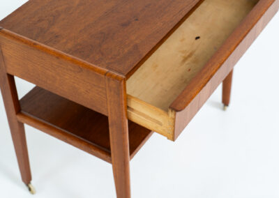Danish trolley / sidetable in teak, 1960s A simple rolling sidetable with one drawer featuring a nicely sculpted handle, a warm woodgrain and some brass details on the wheels. In good condition with normal using traces.