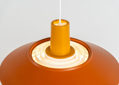 Midcentury pendant light (Denmark, 1960s). It’s made out of an aluminium shade, lacquered in a rusty orange/brown color. Due to the light diffusers on the top and bottom of the lamp there is no direct light harming the eyes. It is restored to perfection and newly rewired. Ready for another lifetime.