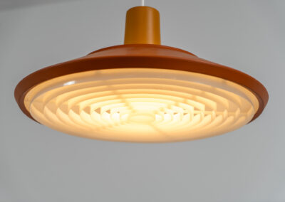 Midcentury pendant light (Denmark, 1960s). It’s made out of an aluminium shade, lacquered in a rusty orange/brown color. Due to the light diffusers on the top and bottom of the lamp there is no direct light harming the eyes. It is restored to perfection and newly rewired. Ready for another lifetime.