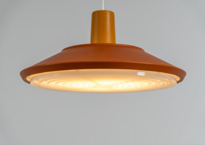 Midcentury pendant light (Denmark, 1960s). It’s made out of an aluminium shade, lacquered in a rusty orange/brown color. Due to the light diffusers on the top and bottom of the lamp there is no direct light harming the eyes. It is restored to perfection and newly rewired. Ready for another lifetime.