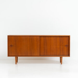 Teak sideboard by Lothar Wegner (Germany, 1960s). A sleek and minimalistic design, as we are used to from Lothar Wegner. It has subtle round inset handles and a beautiful warm woodgrain. Featuring two sliding doors and two shelves on the inside. It’s not very deep so it doesn’t take up much space in the room. In very good condition!