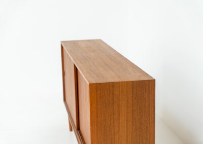 Teak sideboard by Lothar Wegner (Germany, 1960s). A sleek and minimalistic design, as we are used to from Lothar Wegner. It has subtle round inset handles and a beautiful warm woodgrain. Featuring two sliding doors and two shelves on the inside. It’s not very deep so it doesn’t take up much space in the room. In very good condition!