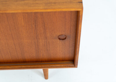 Teak sideboard by Lothar Wegner (Germany, 1960s). A sleek and minimalistic design, as we are used to from Lothar Wegner. It has subtle round inset handles and a beautiful warm woodgrain. Featuring two sliding doors and two shelves on the inside. It’s not very deep so it doesn’t take up much space in the room. In very good condition!