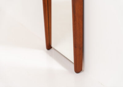Beautiful Mid-Century wall mirror (Denmark, 1960s). It consists of a nicely rounded asymmetrical frame in solid teak. Both the glass and the wood are in very good condition.