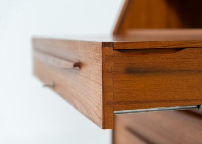 Rare secretary by Bernhard Pedersen & Son (Denmark, 1960s). This is an example of high quality Danish craftsmanship. It features stunning aesthetics and nifty details like the tambour door that opens automatically if you pull the upper drawer or the slidable tray inside the upper drawer. It is in very good condition and marked by the maker on the bottom.