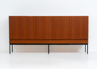 Iconic B60 sideboard in teak by Dieter Wäckerlin for Behr (Germany, 1950s). This highly sought after and significant “B60” sideboard is a masterful blend of minimalistic design and functional elegance. It’s unbelievable this piece was made in the 50’s and is yet so timeless. It contains four drawers and four doors with a minimal gap between them. The inside offers lots of storage space with adjustable shelves. It is in amazing condition with just one minor repair mark, visible on the pictures.