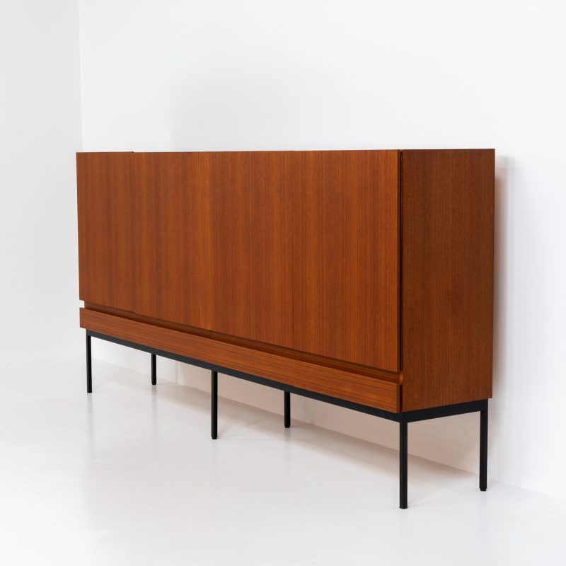 Iconic B60 sideboard in teak by Dieter Wäckerlin for Behr (Germany, 1950s). This highly sought after and significant “B60” sideboard is a masterful blend of minimalistic design and functional elegance. It’s unbelievable this piece was made in the 50’s and is yet so timeless. It contains four drawers and four doors with a minimal gap between them. The inside offers lots of storage space with adjustable shelves. It is in amazing condition with just one minor repair mark, visible on the pictures.