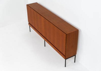 Iconic B60 sideboard in teak by Dieter Wäckerlin for Behr (Germany, 1950s). This highly sought after and significant “B60” sideboard is a masterful blend of minimalistic design and functional elegance. It’s unbelievable this piece was made in the 50’s and is yet so timeless. It contains four drawers and four doors with a minimal gap between them. The inside offers lots of storage space with adjustable shelves. It is in amazing condition with just one minor repair mark, visible on the pictures.
