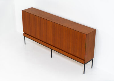 Iconic B60 sideboard in teak by Dieter Wäckerlin for Behr (Germany, 1950s). This highly sought after and significant “B60” sideboard is a masterful blend of minimalistic design and functional elegance. It’s unbelievable this piece was made in the 50’s and is yet so timeless. It contains four drawers and four doors with a minimal gap between them. The inside offers lots of storage space with adjustable shelves. It is in amazing condition with just one minor repair mark, visible on the pictures.