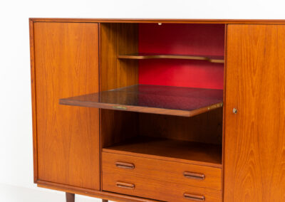 Teak highboard by van Pelt Belgium (Belgium, 1960s). A minimalistic piece made with high quality. It contains two doors with adjustable shelves on this inside, a drop-door with storage space for glasses and bottles, two drawers and an open shelve. The lock of the right door doesn’t work anymore, the key is fixed and the door closes with a magnet. The other locks still work smoothly. The wood is in very good condition with a few spots on the top and on the right side.