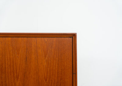 Teak highboard by van Pelt Belgium (Belgium, 1960s). A minimalistic piece made with high quality. It contains two doors with adjustable shelves on this inside, a drop-door with storage space for glasses and bottles, two drawers and an open shelve. The lock of the right door doesn’t work anymore, the key is fixed and the door closes with a magnet. The other locks still work smoothly. The wood is in very good condition with a few spots on the top and on the right side.