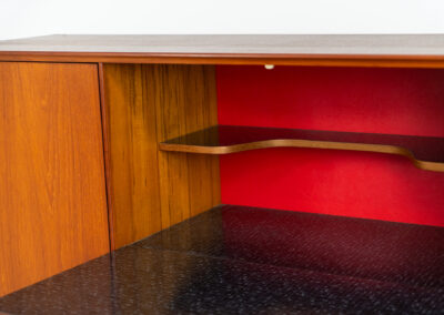 Teak highboard by van Pelt Belgium (Belgium, 1960s). A minimalistic piece made with high quality. It contains two doors with adjustable shelves on this inside, a drop-door with storage space for glasses and bottles, two drawers and an open shelve. The lock of the right door doesn’t work anymore, the key is fixed and the door closes with a magnet. The other locks still work smoothly. The wood is in very good condition with a few spots on the top and on the right side.