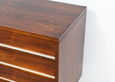 Belgian modernist sideboard in rosewood, 1960s. It features a minimalistic design with sleek lines and chrome details. It offers lots of storage space with two big sliding doors and four drawers. There are clearly traces of use and age like scratches and some color differences, but overall in good condition. We have a matching bar cabinet in stock aswell.