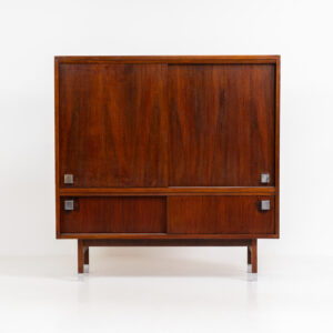 Belgian modernist bar cabinet in rosewood, 1960s. It features a minimalistic design with sleek lines and chrome details. It contains two big and two small sliding doors with lots of storage space on the inside. There are clearly traces of use and age like scratches and some color differences, but overall in good condition. We have a matching sideboard in stock aswell.