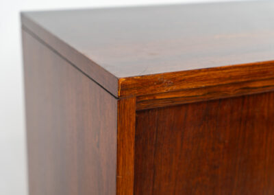 Belgian modernist bar cabinet in rosewood, 1960s. It features a minimalistic design with sleek lines and chrome details. It contains two big and two small sliding doors with lots of storage space on the inside. There are clearly traces of use and age like scratches and some color differences, but overall in good condition. We have a matching sideboard in stock aswell.