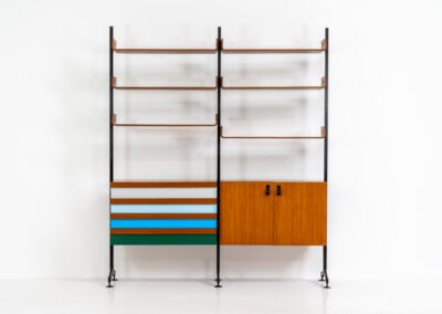 Italian modular wall unit / room devider, 1950s. A wonderful piece combining beautiful shapes, quality and a touch of color. It features a chest of drawers with drawers in four colors, a cabinet with two doors, black steal legs and six very nicely curved shelves. The designer is unknown for now but it’s definitely a stunning piece. The back is finished aswell so it can perfectly serve as a room devider. In very good condition!