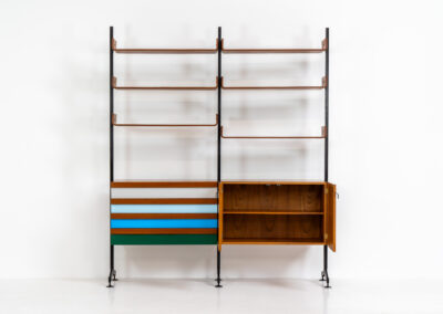 Italian modular wall unit / room devider, 1950s. A wonderful piece combining beautiful shapes, quality and a touch of color. It features a chest of drawers with drawers in four colors, a cabinet with two doors, black steal legs and six very nicely curved shelves. The designer is unknown for now but it’s definitely a stunning piece. The back is finished aswell so it can perfectly serve as a room devider. In very good condition!