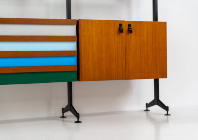 Italian modular wall unit / room devider, 1950s. A wonderful piece combining beautiful shapes, quality and a touch of color. It features a chest of drawers with drawers in four colors, a cabinet with two doors, black steal legs and six very nicely curved shelves. The designer is unknown for now but it’s definitely a stunning piece. The back is finished aswell so it can perfectly serve as a room devider. In very good condition!
