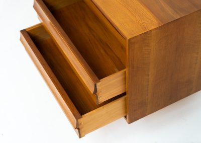 Teak low sideboard from the Platon series by Lothar Wegner (Germany, 1960s). It features two big sliding doors, three drawers and lots of storage space. The combination of the sleek lines and the organic drawers is just amazing. It has subtle round inset handles and a beautiful warm woodgrain. It has some color difference on the top and one of the handles is a little damaged. Otherwise, it is in beautiful condition!