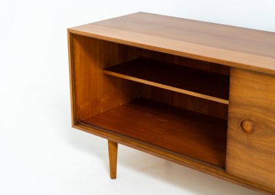 Teak low sideboard from the Platon series by Lothar Wegner (Germany, 1960s). It features two big sliding doors, three drawers and lots of storage space. The combination of the sleek lines and the organic drawers is just amazing. It has subtle round inset handles and a beautiful warm woodgrain. It has some color difference on the top and one of the handles is a little damaged. Otherwise, it is in beautiful condition!