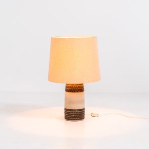 Handmade ceramic table lamp by Einar Johansen for Søholm Stentøj (Denmark, 1960s). This beautiful piece was designed by Einar Johansen and hand made on the Danish island of Bornholm by the company Søholm Stentøj. It features a beautiful graphic pattern with lots of details on the base and a large hessian lamp shade. In very good and original condition.