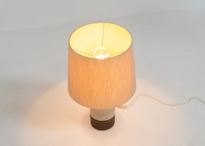 Handmade ceramic table lamp by Einar Johansen for Søholm Stentøj (Denmark, 1960s). This beautiful piece was designed by Einar Johansen and hand made on the Danish island of Bornholm by the company Søholm Stentøj. It features a beautiful graphic pattern with lots of details on the base and a large hessian lamp shade. In very good and original condition.