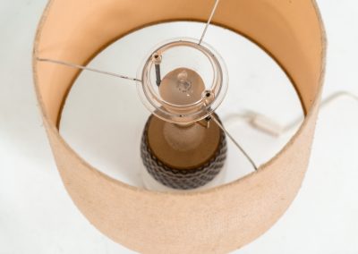 Handmade ceramic table lamp by Einar Johansen for Søholm Stentøj (Denmark, 1960s). This beautiful piece was designed by Einar Johansen and hand made on the Danish island of Bornholm by the company Søholm Stentøj. It features a beautiful graphic pattern with lots of details on the base and a large hessian lamp shade. In very good and original condition.