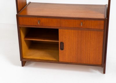 Teak shelving system / room devider (Sweden, 1960s). A very nice piece featuring two sliding doors, two drawers and three adjustable shelves. It’s sleek minimalist design combined with a wonderful warm woodgrain are a perfect match. With its finished back, this versatile piece can be used as a room divider aswell, making it a perfect addition to any space. In excellent condition! Comes with the original keys.